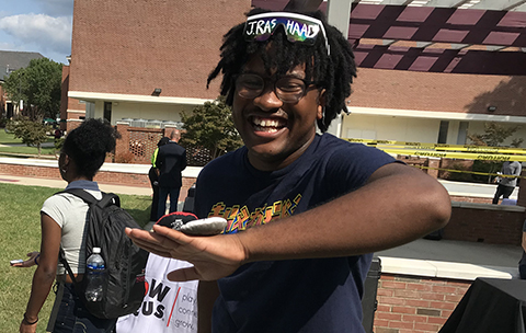 College student smiling with Flop Balls on hand.