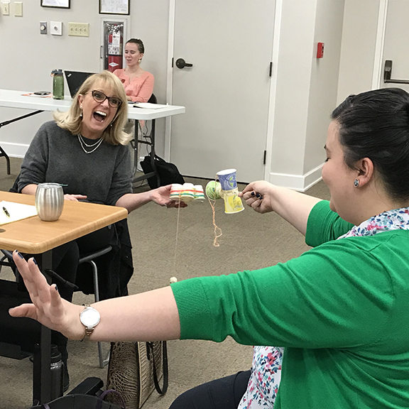 Librarians laughing while sharing their Fundama DIY skill toy for summer reading program.